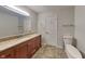 Bathroom featuring vanity with granite counters, a large mirror and updated fixtures at 5939 Brendonridge S Ct, Indianapolis, IN 46226
