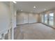 Spacious living room with neutral carpet and French doors leading to the outside at 5939 Brendonridge S Ct, Indianapolis, IN 46226