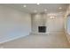 Comfortable living room with a tiled fireplace, plush carpeting, and recessed lighting at 5939 Brendonridge S Ct, Indianapolis, IN 46226
