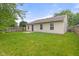 Spacious backyard with lush green grass, a wood fence, and the rear of the house at 6227 Long River Ln, Indianapolis, IN 46221
