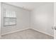 Neutral bedroom features a light gray carpet, a window with blinds, and white walls at 6227 Long River Ln, Indianapolis, IN 46221