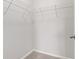 Walk-in closet featuring ample shelving and neutral carpeting for organized storage at 6227 Long River Ln, Indianapolis, IN 46221