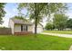 Charming single-story home with a well-maintained lawn, a playground in the background at 6227 Long River Ln, Indianapolis, IN 46221