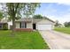 Charming single-story home with a well-maintained lawn and two-car garage at 6227 Long River Ln, Indianapolis, IN 46221