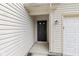 Close-up of the black front door with white trim and a light fixture at 6227 Long River Ln, Indianapolis, IN 46221