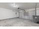 Spacious two-car garage with concrete floor, overhead lighting, and garage door opener at 6227 Long River Ln, Indianapolis, IN 46221