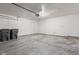 Empty two-car garage with concrete floor, overhead lighting, and a service door at 6227 Long River Ln, Indianapolis, IN 46221