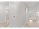 Bright hallway with neutral walls, tiled floor, and doors leading to rooms at 6227 Long River Ln, Indianapolis, IN 46221