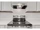 Close-up of stainless steel stove with glass cooktop and hood at 6227 Long River Ln, Indianapolis, IN 46221