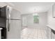 Bright kitchen featuring stainless steel appliances, tile flooring, and a modern light fixture at 6227 Long River Ln, Indianapolis, IN 46221