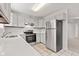 Contemporary kitchen with white cabinets, stainless steel appliances, and countertops at 6227 Long River Ln, Indianapolis, IN 46221