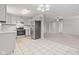 Open-concept kitchen featuring white cabinets, stainless steel appliances, and tile floors at 6227 Long River Ln, Indianapolis, IN 46221