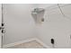 Small laundry room with tiled floors, wire shelving, and utility connections at 6227 Long River Ln, Indianapolis, IN 46221