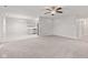 Open-concept living room showing kitchen with white cabinets and stainless steel appliances at 6227 Long River Ln, Indianapolis, IN 46221