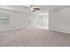 Bright living room featuring neutral paint, plush carpet, a ceiling fan and natural light at 6227 Long River Ln, Indianapolis, IN 46221