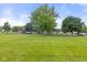 Enjoy the community playground area, perfect for families, with swings and a play structure set amongst mature trees at 6227 Long River Ln, Indianapolis, IN 46221