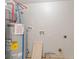 Basement mechanical room with water heater, pipes, and fixtures at 6310 Kellum Dr, Indianapolis, IN 46221
