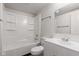 Bathroom with white fixtures, tub-shower combo, and vanity sink at 6310 Kellum Dr, Indianapolis, IN 46221