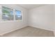 Bedroom features neutral walls and carpet, window with neighborhood view at 6310 Kellum Dr, Indianapolis, IN 46221