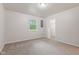 Spacious bedroom features neutral carpet, gray walls, natural light, and a closet at 6310 Kellum Dr, Indianapolis, IN 46221