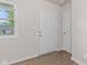 Bright entryway featuring clean white trim, fresh paint and stylish laminate flooring at 6310 Kellum Dr, Indianapolis, IN 46221