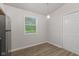 Bright eating area in kitchen featuring a window, exterior door, and gray walls at 6310 Kellum Dr, Indianapolis, IN 46221