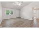 Bright living room featuring new laminate flooring, neutral walls, and ample natural light at 6310 Kellum Dr, Indianapolis, IN 46221