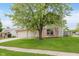Charming two-story home features a well-manicured lawn, brick accents, and a welcoming front entrance at 6320 River Valley Way, Indianapolis, IN 46221