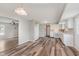 Open concept kitchen with hard wood floors connecting to living room, white cabinets, and ample counter space at 6320 River Valley Way, Indianapolis, IN 46221