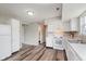 The kitchen has stainless steel sink, white cabinets, and modern appliances at 6320 River Valley Way, Indianapolis, IN 46221