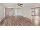 Open-concept living room with hardwood floors, staircase, and seamless transition to the adjacent kitchen at 6320 River Valley Way, Indianapolis, IN 46221