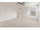 Large bedroom with a ceiling fan, plush carpet, and natural light creates a comfortable and inviting space at 6332 Long River Ln, Indianapolis, IN 46221