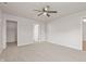 Spacious bedroom with plush carpet, a ceiling fan, and two closets, offering comfort and ample storage at 6332 Long River Ln, Indianapolis, IN 46221