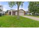Traditional home with a two car garage, neat landscaping, and lush green lawn at 6332 Long River Ln, Indianapolis, IN 46221