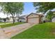 Traditional home with a driveway, two car garage, neat landscaping, and lush green lawn at 6332 Long River Ln, Indianapolis, IN 46221