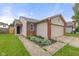 Home with neat landscaping, including greenery in front, and a two car garage at 6332 Long River Ln, Indianapolis, IN 46221