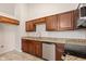 Close up of kitchen featuring granite countertops, stainless steel appliances, and tile flooring at 6332 Long River Ln, Indianapolis, IN 46221