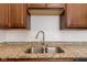 Granite countertops with a double stainless steel sink and a modern faucet at 6332 Long River Ln, Indianapolis, IN 46221