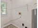 Well-organized laundry room featuring a wire shelf, washer hook-up, and a pegboard for convenient storage options at 6332 Long River Ln, Indianapolis, IN 46221
