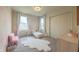 Cozy bedroom with a floral wall accent, a pink chair, and plenty of natural light at 640 Axford Bay Dr, Westfield, IN 46074