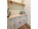 Butler's pantry with white cabinets, wood countertop and floating shelf. Perfect for a coffee bar at 640 Axford Bay Dr, Westfield, IN 46074