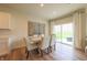 Elegant dining area features a dining table with six chairs, modern art, and sliding glass doors at 640 Axford Bay Dr, Westfield, IN 46074