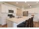 Bright kitchen features white cabinets, stainless steel appliances, and a large island with bar seating at 640 Axford Bay Dr, Westfield, IN 46074