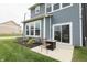 Relaxing outdoor patio with wicker chairs and a fire pit, perfect for enjoying the landscaped backyard at 640 Axford Bay Dr, Westfield, IN 46074
