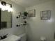 Cozy bathroom features stylish decor, shelving, and a vanity with a mirror at 6714 Colleens Way, Indianapolis, IN 46221