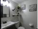 A well-lit bathroom offers a modern vanity, floating shelves, and tasteful decor at 6714 Colleens Way, Indianapolis, IN 46221