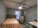 Neutral bedroom featuring a ceiling fan, natural light, and ample storage at 6714 Colleens Way, Indianapolis, IN 46221