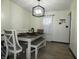 Light filled dining room with a table, bench seating and views of the outdoors at 6714 Colleens Way, Indianapolis, IN 46221