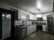 Bright kitchen with white cabinets, stainless steel appliances and tile backsplash at 6714 Colleens Way, Indianapolis, IN 46221