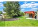 Expansive backyard featuring a fire pit, a wooden pergola, and a privacy fence at 6842 Sextant Dr, Indianapolis, IN 46260